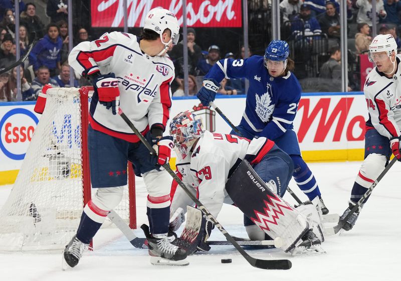 Dec 6, 2024; Toronto, Ontario, CAN; Toronto Maple Leafs left wing Matthew Knies (23) looks for the rebound in front of Washington Capitals goaltender Charlie Lindgren (79) during the first period at Scotiabank Arena. Mandatory Credit: Nick Turchiaro-Imagn Images