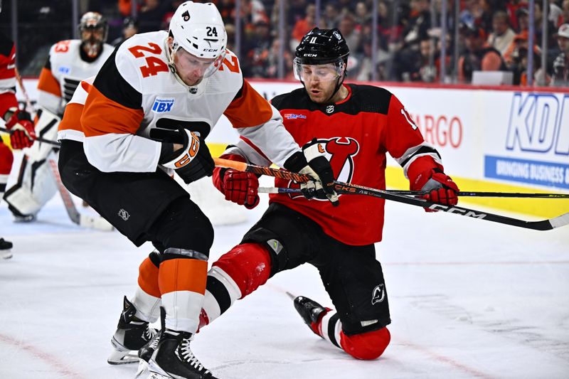 Apr 13, 2024; Philadelphia, Pennsylvania, USA; New Jersey Devils center Chris Tierney (11) and Philadelphia Flyers defenseman Nick Seeler (24) battle for the puck in the second period at Wells Fargo Center. Mandatory Credit: Kyle Ross-USA TODAY Sports