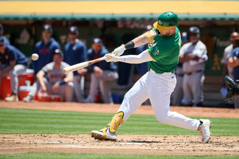 May 26, 2024; Oakland, California, USA; Oakland Athletics outfielder Seth Brown (15) hits a single against the Houston Astros during the second inning at Oakland-Alameda County Coliseum. Mandatory Credit: Robert Edwards-USA TODAY Sports