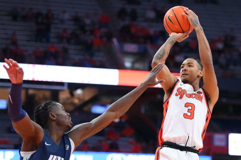 Nov 6, 2023; Syracuse, New York, USA; Syracuse Orange guard Judah Mintz (3) shoots the ball as New Hampshire Wildcats forward Clarence Daniels (left) defends during the second half at the JMA Wireless Dome. Mandatory Credit: Rich Barnes-USA TODAY Sports