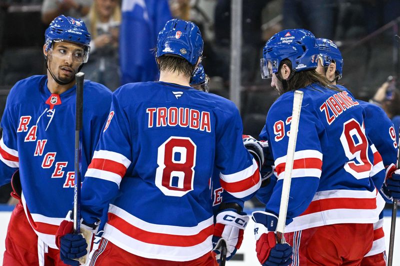 Oct 14, 2024; New York, New York, USA;  New York Rangers celebrate the empty net goal by New York Rangers center Mika Zibanejad (93) against the Detroit Red Wings during the third period at Madison Square Garden. Mandatory Credit: Dennis Schneidler-Imagn Images