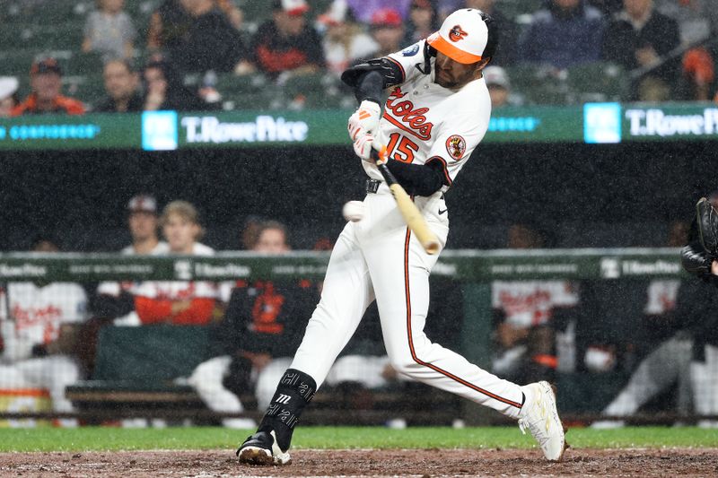 Sep 10, 2025; Baltimore, Maryland, USA; Baltimore Orioles outfielder Dylan Carlson (15) hits a single during the eighth  inning against the Pittsburgh Pirates at Oriole Park at Camden Yards. Mandatory Credit: Daniel Kucin Jr.-Imagn Images