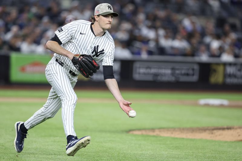 May 18, 2025; Bronx, New York, USA;  New York Yankees starting pitcher Max Fried (54) throws a runner out at first base in the fifth inning against the New York Mets at Yankee Stadium. Mandatory Credit: Wendell Cruz-Imagn Images