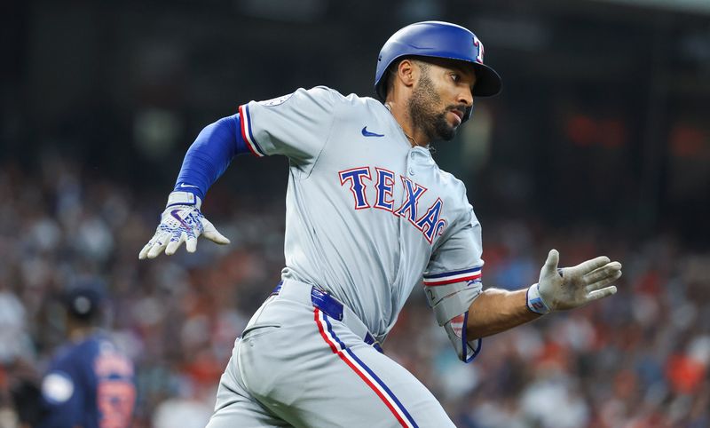 Apr 14, 2024; Houston, Texas, USA; Texas Rangers second baseman Marcus Semien (2) runs to first base on an RBI double during the fifth inning against the Houston Astros at Minute Maid Park. Mandatory Credit: Troy Taormina-USA TODAY Sports