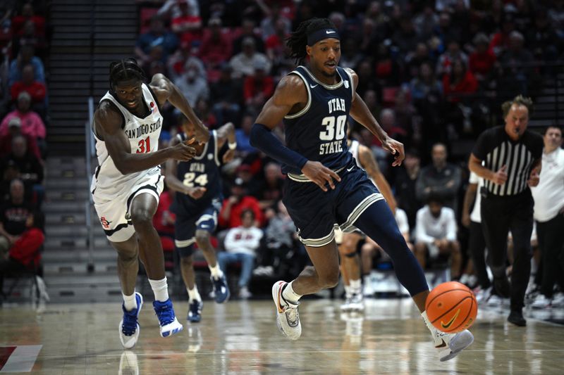 Jan 25, 2023; San Diego, California, USA; Utah State Aggies forward Dan Akin (30) chases a loose ball ahead of San Diego State Aztecs forward Nathan Mensah (31) during the second half at Viejas Arena. Mandatory Credit: Orlando Ramirez-USA TODAY Sports