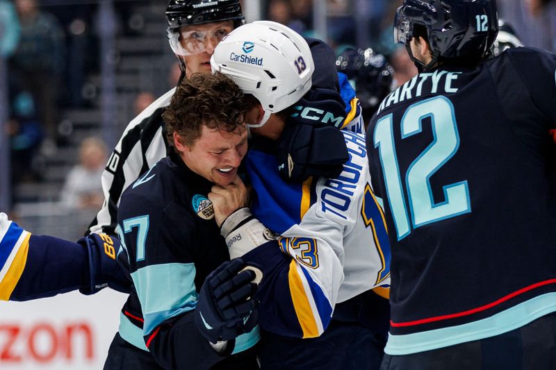 Oct 8, 2024; Seattle, Washington, USA; Seattle Kraken center Yanni Gourde (37) and St. Louis Blues right wing Alexey Toropchenko (13) scuffle during the second period at Climate Pledge Arena. Mandatory Credit: Caean Couto-Imagn Images