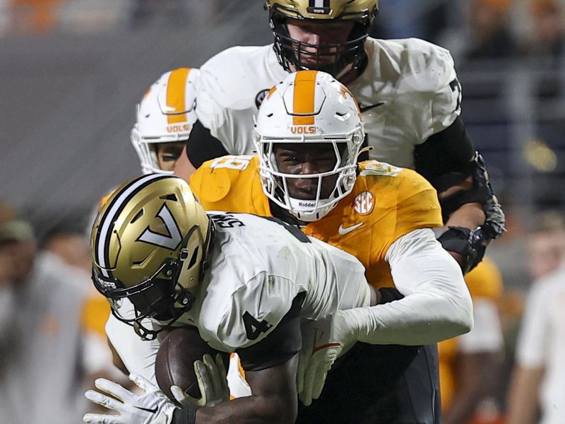 Nov 25, 2023; Knoxville, Tennessee, USA; Tennessee Volunteers defensive lineman Joshua Josephs (19) tackles Vanderbilt Commodores running back Patrick Smith (4) during the second half at Neyland Stadium. Mandatory Credit: Randy Sartin-USA TODAY Sports