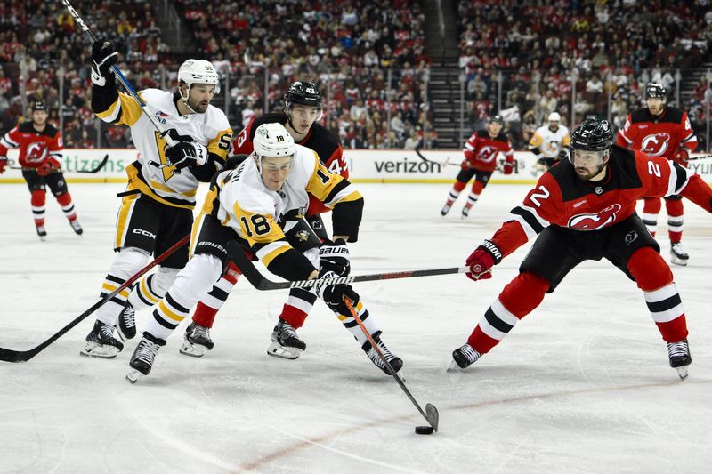 Apr 2, 2024; Newark, New Jersey, USA; Pittsburgh Penguins right wing Jesse Puljujarvi (18) skates with the puck while being defended by New Jersey Devils defenseman Luke Hughes (43) and New Jersey Devils defenseman Brendan Smith (2) during the first period at Prudential Center. Mandatory Credit: John Jones-USA TODAY Sports