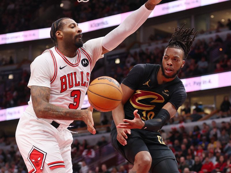 CHICAGO, ILLINOIS - FEBRUARY 28: Darius Garland #10 of the Cleveland Cavaliers passes around Andre Drummond #3 of the Chicago Bulls during the first half at the United Center on February 28, 2024 in Chicago, Illinois. NOTE TO USER: User expressly acknowledges and agrees that, by downloading and or using this photograph, User is consenting to the terms and conditions of the Getty Images License Agreement. (Photo by Michael Reaves/Getty Images)