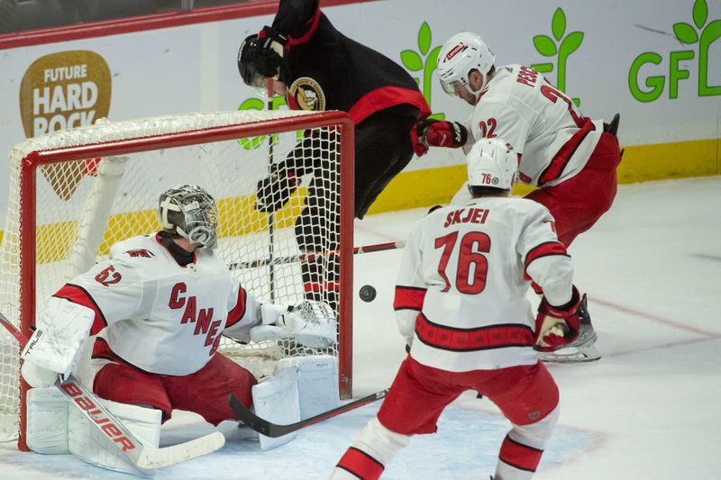 Dec 12, 2023; Ottawa, Ontario, CAN; Carolina Hurricanes goalie Pyotrt Kochetkov (52) makes a save in the third period against the Ottawa Senators at the Canadian Tire Centre. Mandatory Credit: Marc DesRosiers-USA TODAY Sports.