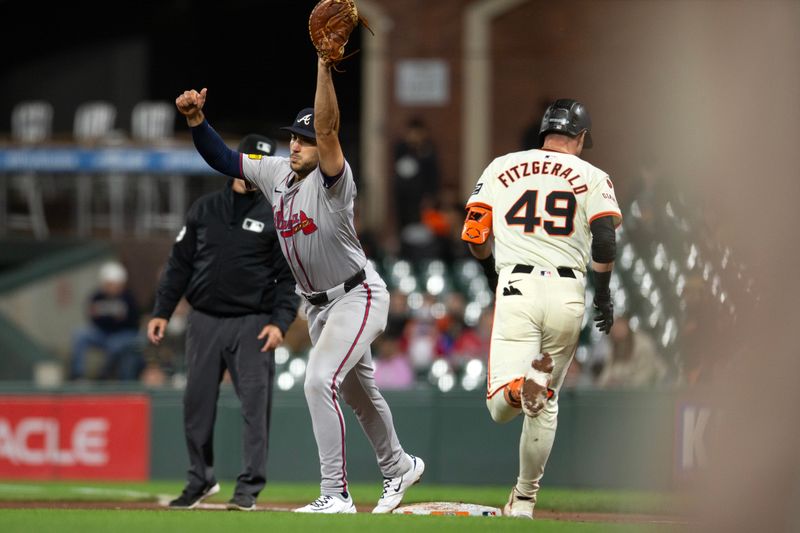 Aug 14, 2024; San Francisco, California, USA; Atlanta Braves first baseman Matt Olson (28) takes the throw at first base to put out San Francisco Giants shortstop Tyler Fitzgerald (49) for the final out of the ninth inning at Oracle Park. Mandatory Credit: D. Ross Cameron-USA TODAY Sports