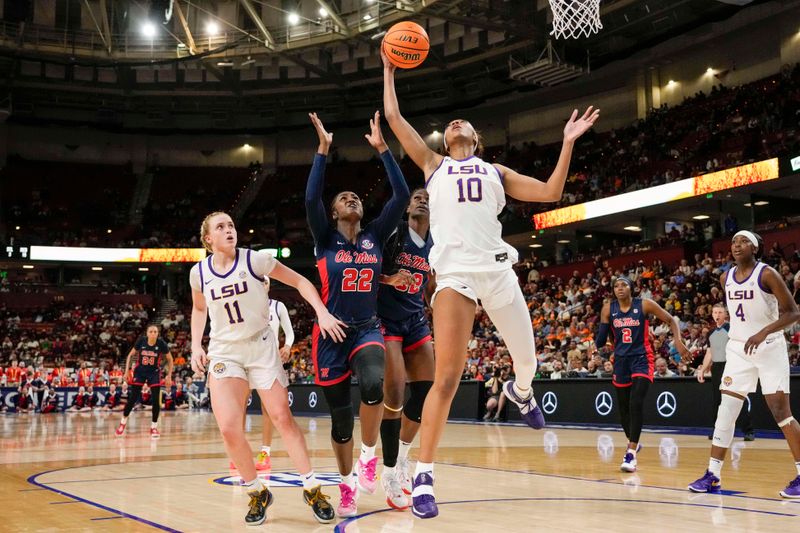 Mar 9, 2024; Greensville, SC, USA; LSU Lady Tigers forward Angel Reese (10) grabs a rebound over Ole Miss Rebels forward Tyia Singleton (22) during the first half at Bon Secours Wellness Arena. Mandatory Credit: Jim Dedmon-USA TODAY Sports