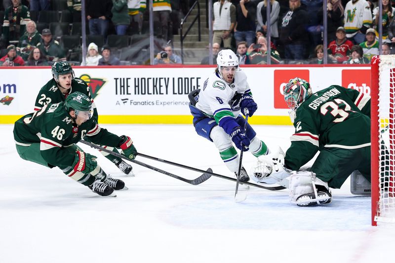 Dec 3, 2024; Saint Paul, Minnesota, USA; Minnesota Wild goaltender Filip Gustavsson (32) makes a save on a shot by Vancouver Canucks right wing Conor Garland (8) during overtime at Xcel Energy Center. Mandatory Credit: Matt Krohn-Imagn Images