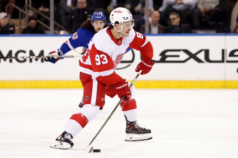 Nov 29, 2023; New York, New York, USA; Detroit Red Wings right wing Alex DeBrincat (93) brings the puck up ice against New York Rangers center Mika Zibanejad (93) during the second period at Madison Square Garden. Mandatory Credit: Brad Penner-USA TODAY Sports