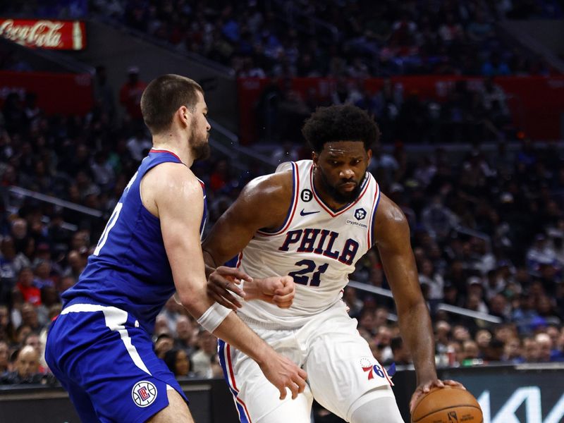 LOS ANGELES, CALIFORNIA - JANUARY 17:  Joel Embiid #21 of the Philadelphia 76ers controls the ball against Ivica Zubac #40 of the LA Clippers in the second half at Crypto.com Arena on January 17, 2023 in Los Angeles, California.  NOTE TO USER: User expressly acknowledges and agrees that, by downloading and/or using this photograph, user is consenting to the terms and conditions of the Getty Images License Agreement.  (Photo by Ronald Martinez/Getty Images)