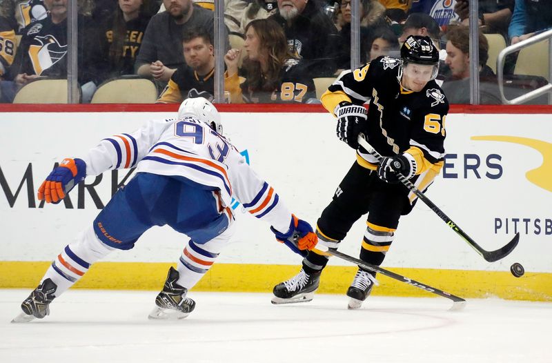 Feb 23, 2023; Pittsburgh, Pennsylvania, USA;  Pittsburgh Penguins left wing Jake Guentzel (59) moves the puck against Edmonton Oilers center Ryan Nugent-Hopkins (93) during the second period at PPG Paints Arena. Mandatory Credit: Charles LeClaire-USA TODAY Sports