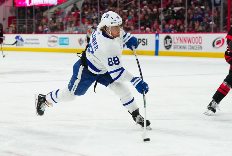 Mar 24, 2024; Raleigh, North Carolina, USA;  Toronto Maple Leafs right wing William Nylander (88) takes a shot against the Carolina Hurricanes during the second period at PNC Arena. Mandatory Credit: James Guillory-USA TODAY Sports