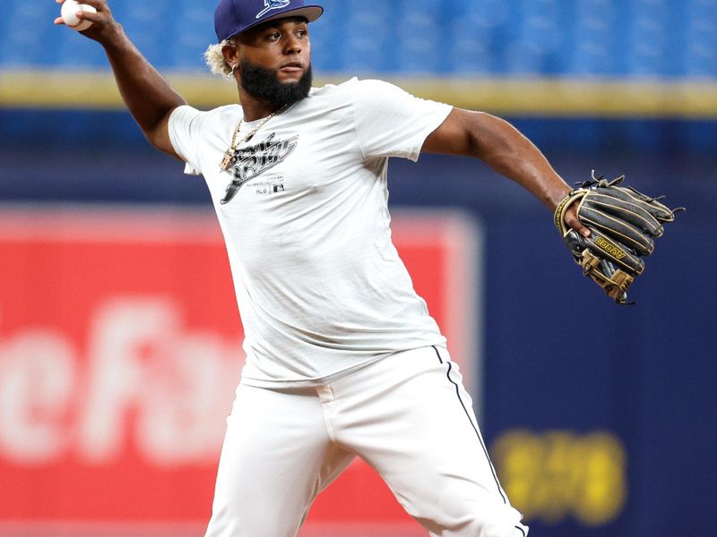 Aug 13, 2024; St. Petersburg, Florida, USA; Tampa Bay Rays third baseman Junior Caminero (13) takes fielding practice before a game against the Houston Astros at Tropicana Field. Mandatory Credit: Nathan Ray Seebeck-USA TODAY Sports