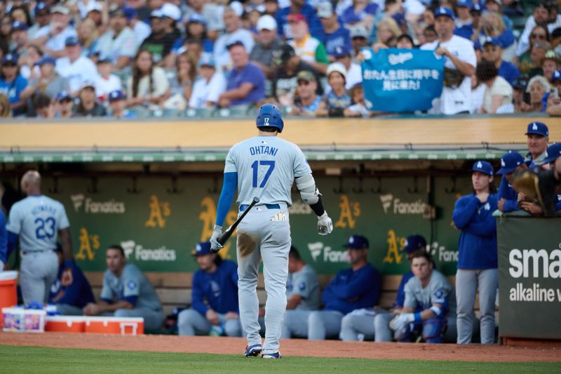 Aug 3, 2024; Oakland, California, USA; Los Angeles Dodgers designated hitter Shohei Ohtani (17) walks back to the dugout after striking out against the Oakland Athletics during the third inning at Oakland-Alameda County Coliseum. Mandatory Credit: Robert Edwards-USA TODAY Sports