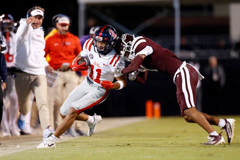 Nov 23, 2023; Starkville, Mississippi, USA; Mississippi Rebels wide receiver Jordan Watkins (11) runs after a catch for a first down as Mississippi State Bulldogs defensive back Marcus Banks (1) pushes him out of bounds during the second half  at Davis Wade Stadium at Scott Field. Mandatory Credit: Petre Thomas-USA TODAY Sports