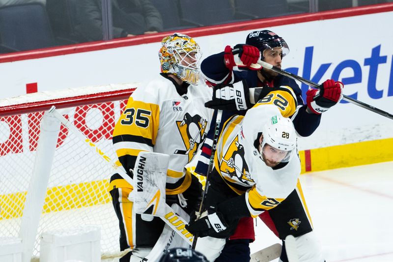 Feb 10, 2024; Winnipeg, Manitoba, CAN;  Pittsburgh Penguins defenseman Marcus Pettersson (28) jostles for position with Winnipeg Jets forward Nino Niederreiter (62) in front of Pittsburgh Penguins goalie Tristan Jarry (35) during the third period at Canada Life Centre. Mandatory Credit: Terrence Lee-USA TODAY Sports