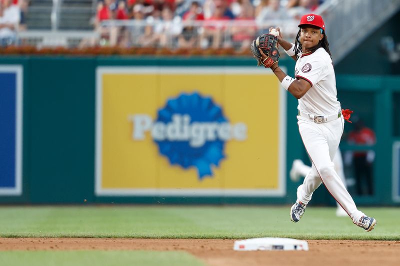 Jul 19, 2024; Washington, District of Columbia, USA; Washington Nationals shortstop CJ Abrams (5) makes a throw to first base on a ground ball hit by Cincinnati Reds outfielder Stuart Fairchild (not pictured) during the fifth inning at Nationals Park. Mandatory Credit: Geoff Burke-USA TODAY Sports