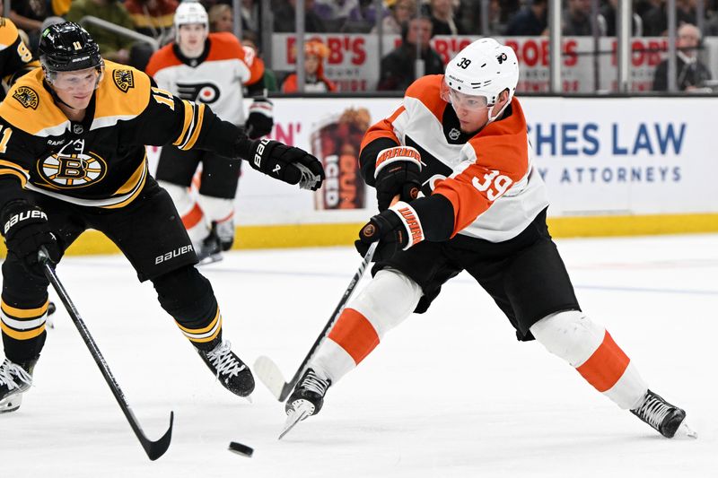 Oct 1, 2024; Boston, Massachusetts, USA; Philadelphia Flyers right wing Matvei Michkov (39) takes in shot in front of Boston Bruins center Trent Frederic (11) during the second period at the TD Garden. Mandatory Credit: Brian Fluharty-Imagn Images