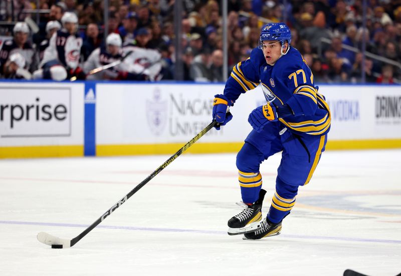 Dec 30, 2023; Buffalo, New York, USA;  Buffalo Sabres right wing JJ Peterka (77) skates up ice with the puck during the second period against the Columbus Blue Jackets at KeyBank Center. Mandatory Credit: Timothy T. Ludwig-USA TODAY Sports