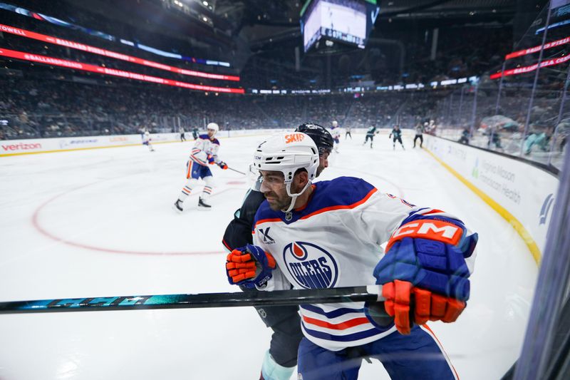 Nov 29, 2025; Seattle, Washington, USA;  Edmonton Oilers defenseman Evan Bouchard (2) is checked by Seattle Kraken right wing Jordan Eberle (7) in the first period at Climate Pledge Arena. Mandatory Credit: Kevin Ng-Imagn Images