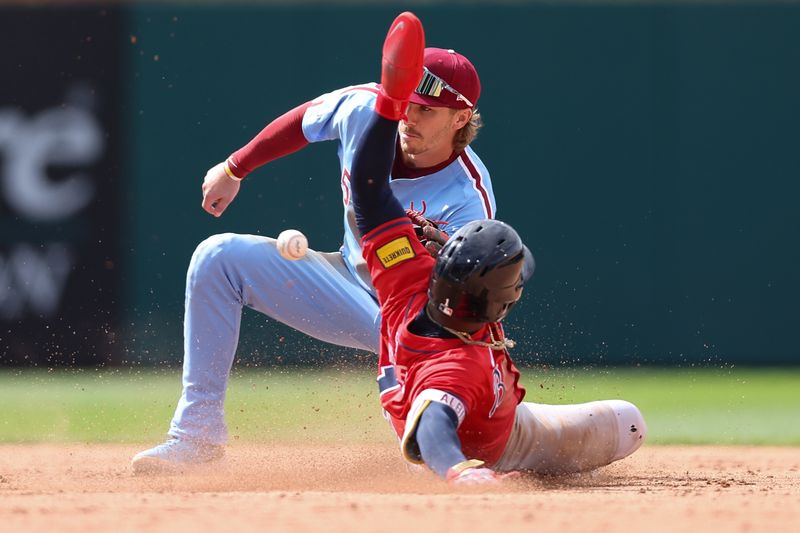 May 29, 2025; Philadelphia, Pennsylvania, USA; Philadelphia Phillies second base Bryson Stott (5) tags out Atlanta Braves second base Ozzie Albies (1) on a stolen base attempt during the ninth inning at Citizens Bank Park. Mandatory Credit: Bill Streicher-Imagn Images