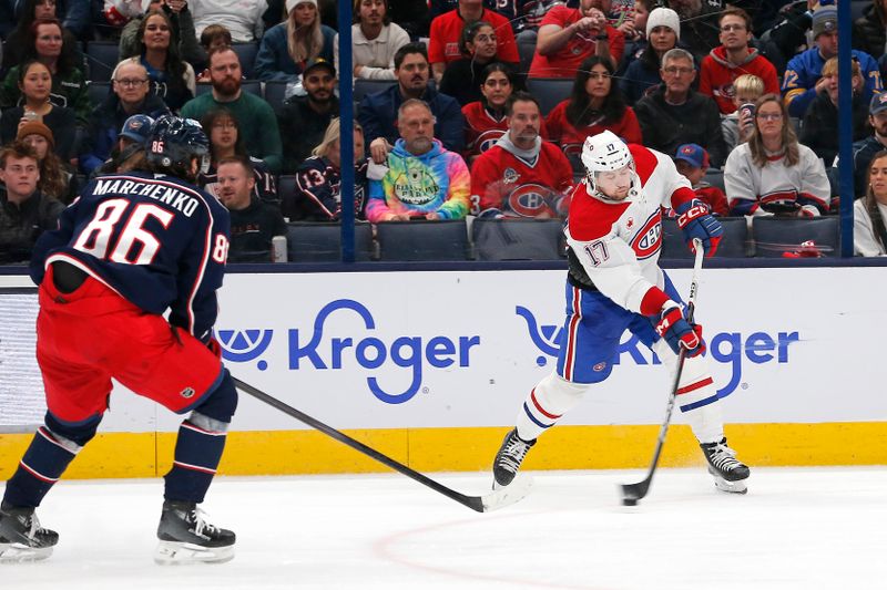 Nov 27, 2024; Columbus, Ohio, USA; Montreal Canadiens right wing Josh Anderson (17) shoots on goal as Columbus Blue Jackets right wing Kirill Marchenko (86) trails the play during the second period at Nationwide Arena. Mandatory Credit: Russell LaBounty-Imagn Images