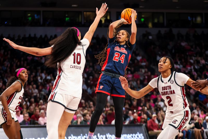 Feb 4, 2024; Columbia, South Carolina, USA; Ole Miss Rebels forward Madison Scott (24) shoots over South Carolina Gamecocks center Kamilla Cardoso (10) in the second half at Colonial Life Arena. Mandatory Credit: Jeff Blake-USA TODAY Sports