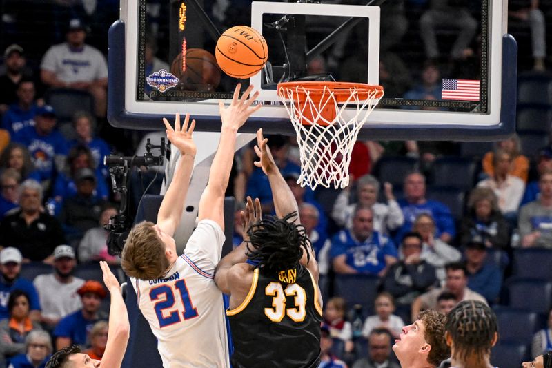Mar 14, 2025; Nashville, TN, USA;  Florida Gators forward Alex Condon (21) lays the ball in over Missouri Tigers center Josh Gray (33) during the second half at Bridgestone Arena. Mandatory Credit: Steve Roberts-Imagn Images