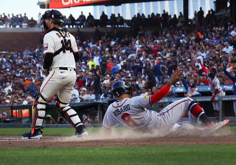 Aug 27, 2023; San Francisco, California, USA; Atlanta Braves left fielder Eddie Rosario (8) scores a run below San Francisco Giants catcher Patrick Bailey (14) during the fifth inning at Oracle Park. Mandatory Credit: Kelley L Cox-USA TODAY Sports