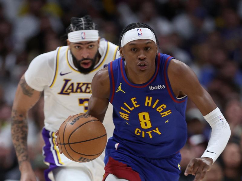 DENVER, COLORADO - APRIL 20: Peyton Watson #8 of the Denver Nuggets brings the ball down the court against the Los Angeles Lakers in the fourth quarter during game one of the Western Conference First Round Playoffs at Ball Arena on April 20, 2024 in Denver, Colorado.  NOTE TO USER: User expressly acknowledges and agrees that, by downloading and or using this photograph, User is consenting to the terms and conditions of the Getty Images License Agreement. (Photo by Matthew Stockman/Getty Images)