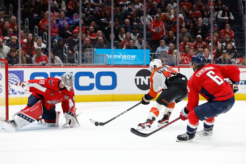 Oct 23, 2024; Washington, District of Columbia, USA; Washington Capitals goaltender Logan Thompson (48) makes a save on Philadelphia Flyers center Morgan Frost (48) as Capitals defenseman Jakob Chychrun (6) chases in the second period at Capital One Arena. Mandatory Credit: Geoff Burke-Imagn Images