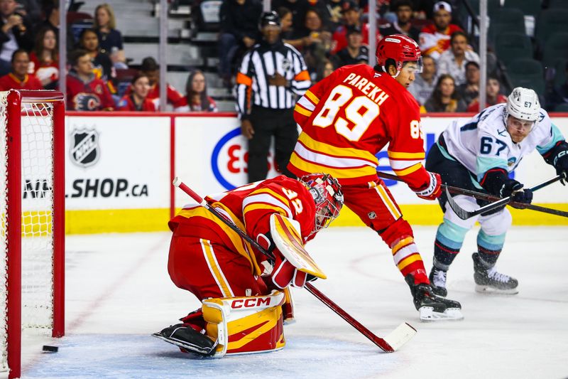 Sep 23, 2025; Calgary, Alberta, CAN; Seattle Kraken center Mitchell Stephens (67) scores a goal against Calgary Flames goaltender Dustin Wolf (32) during the first period at Scotiabank Saddledome. Mandatory Credit: Sergei Belski-Imagn Images