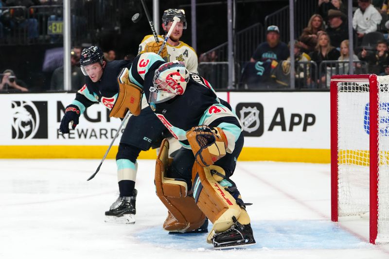 Mar 21, 2024; Las Vegas, Nevada, USA; Seattle Kraken goaltender Philipp Grubauer (31) makes a shoulder save as Seattle Kraken defenseman Will Borgen (3) fends off Vegas Golden Knights center Jack Eichel (9) during the second period at T-Mobile Arena. Mandatory Credit: Stephen R. Sylvanie-USA TODAY Sports