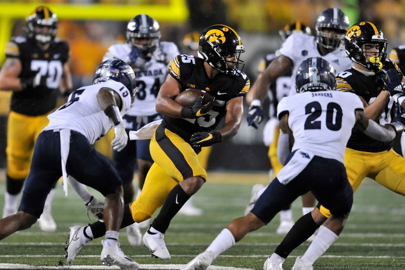 Sep 17, 2022; Iowa City, Iowa, USA; Iowa Hawkeyes running back Gavin Williams (25) runs the ball against the Nevada Wolf Pack during the second quarter at Kinnick Stadium. Mandatory Credit: Jeffrey Becker-USA TODAY Sports