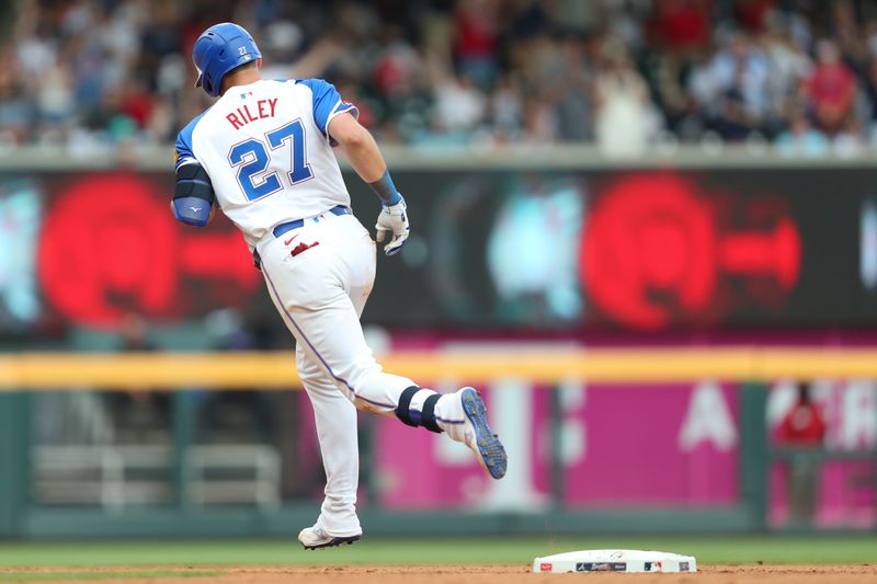 Jun 15, 2024; Cumberland, Georgia, USA; Atlanta Braves third baseman Austin Riley (27) hits a home run against the Tampa Bay Rays during the seventh inning at Truist Park. Mandatory Credit: Mady Mertens-USA TODAY Sports