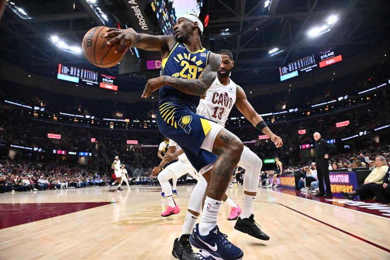 CLEVELAND, OHIO - APRIL 13: Quenton Jackson #29 of the Indiana Pacers passes around Tristan Thompson #13 of the Cleveland Cavaliers during the second quarter at Rocket Arena on April 13, 2025 in Cleveland, Ohio. NOTE TO USER: User expressly acknowledges and agrees that, by downloading and or using this photograph, User is consenting to the terms and conditions of the Getty Images License Agreement. (Photo by Jason Miller/Getty Images)