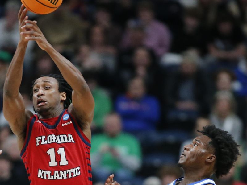 Mar 17, 2023; Columbus, OH, USA; Florida Atlantic Owls guard Michael Forrest (11) attempts to control the ball pressured by Memphis Tigers guard Damaria Franklin (55) in the first half at Nationwide Arena. Mandatory Credit: Joseph Maiorana-USA TODAY Sports