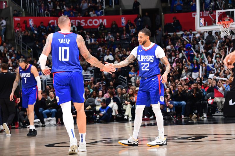 LOS ANGELES, CA - APRIL 12: Daniel Theis #10 and Xavier Moon #22 of the LA Clippers high five during the game against the Utah Jazz on April 12, 2024 at Crypto.Com Arena in Los Angeles, California. NOTE TO USER: User expressly acknowledges and agrees that, by downloading and/or using this Photograph, user is consenting to the terms and conditions of the Getty Images License Agreement. Mandatory Copyright Notice: Copyright 2024 NBAE (Photo by Adam Pantozzi/NBAE via Getty Images)