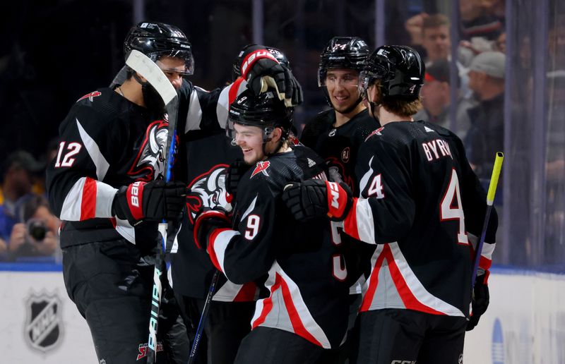 Mar 12, 2024; Buffalo, New York, USA;  Buffalo Sabres left wing Zach Benson (9) celebrates his goal with teammates during the first period against the Detroit Red Wings at KeyBank Center. Mandatory Credit: Timothy T. Ludwig-USA TODAY Sports