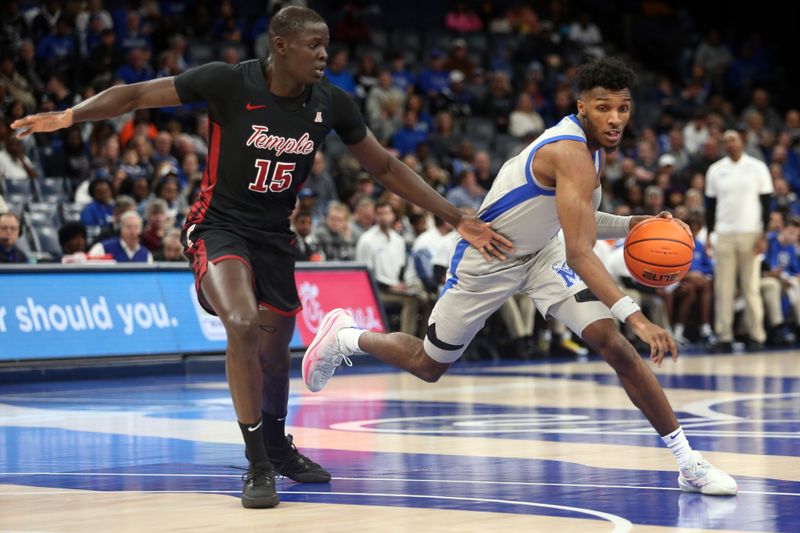 Feb 12, 2023; Memphis, Tennessee, USA; Memphis Tigers guard Keonte Kennedy (1) dribbles as Temple Owls forward Kur Jongkuch (15) defends during the first half at FedExForum. Mandatory Credit: Petre Thomas-USA TODAY Sports