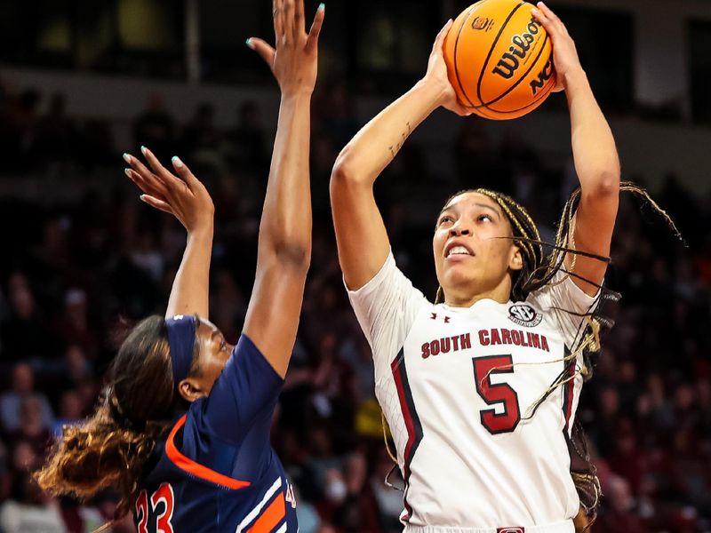 Jan 5, 2023; Columbia, South Carolina, USA; South Carolina Gamecocks forward Victaria Saxton (5) shoots over Auburn Tigers forward Kharyssa Richardson (33) in the first half at Colonial Life Arena. Mandatory Credit: Jeff Blake-USA TODAY Sports