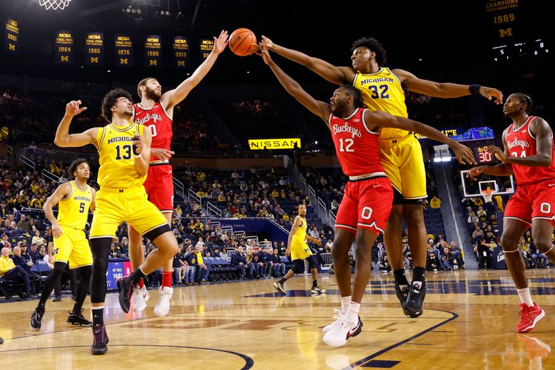 Jan 15, 2024; Ann Arbor, Michigan, USA; Ohio State Buckeyes forward Jamison Battle (10), guard Evan Mahaffey (12), and Michigan Wolverines forward Tarris Reed Jr. (32) go for the rebound in the first half at Crisler Center. Mandatory Credit: Rick Osentoski-USA TODAY Sports