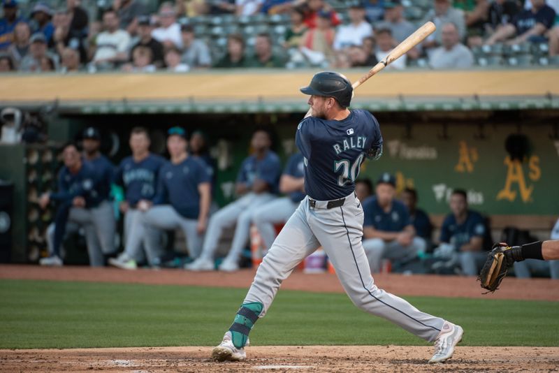 Jun 4, 2024; Oakland, California, USA; Seattle Mariners outfielder Luke Raley (20) hits a double against the Oakland Athletics during the third inning at Oakland-Alameda County Coliseum. Mandatory Credit: Ed Szczepanski-USA TODAY Sports