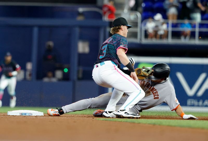 May 31, 2025; Miami, Florida, USA;  San Francisco Giants center fielder Jung Hoo Lee (51) steals second under the tag of Miami Marlins second baseman Jack Winkler (63)  during the first inning at loanDepot Park. Mandatory Credit: Rhona Wise-Imagn Images
