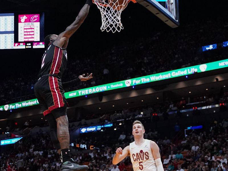 MIAMI, FLORIDA - MARCH 24: Terry Rozier #2 of the Miami Heat dunks the ball over Sam Merrill #5 of the Cleveland Cavaliers during the third quarter at Kaseya Center on March 24, 2024 in Miami, Florida. NOTE TO USER: User expressly acknowledges and agrees that, by downloading and or using this photograph, User is consenting to the terms and conditions of the Getty Images License Agreement. (Photo by Rich Storry/Getty Images)